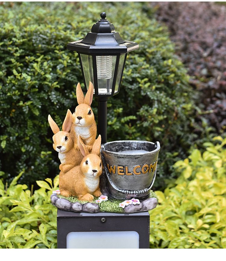 Solar Simulation Rabbit Ornament, charges by day and lights up automatically at night, three rabbits cluster around a street lamp with "WELCOME" bucket, warmly decorates courtyard and balcony, eco-friendly and healing./Rabbit's Kin